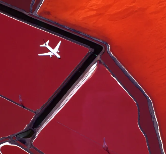 Exceptional Connectivity Aerial photo of a white plane flying above a red landscape
