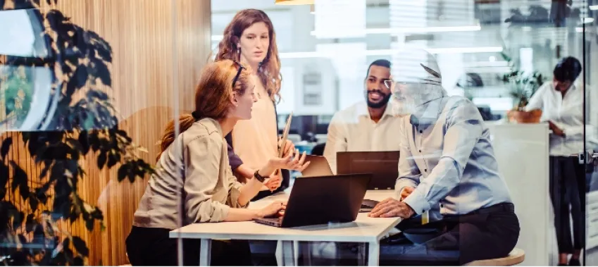 Exceptional Connectivity Photo of employees having a business meeting with their laptops